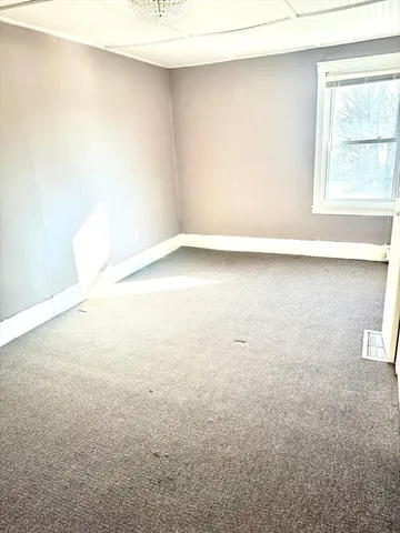 an empty room with a windows
