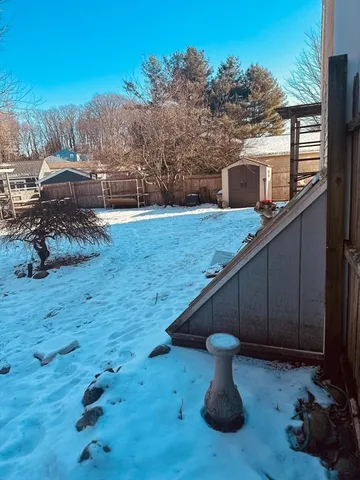 a view of a backyard with wooden fence