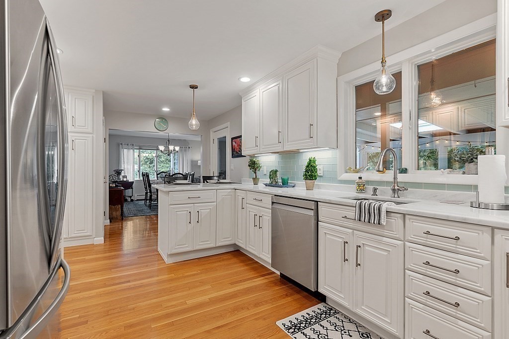 14 Scenna Road Beverly, MA 01915 - Photo 13 of 42 a kitchen with kitchen island white cabinets and white appliances