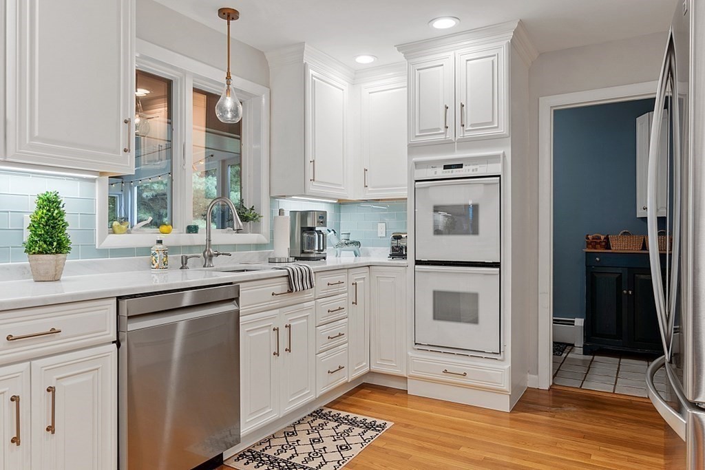 14 Scenna Road Beverly, MA 01915 - Photo 14 of 42 a kitchen with white cabinets and white appliances