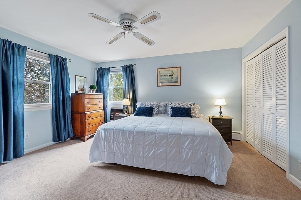 14 Scenna Road Beverly, MA 01915 - Photo 21 of 42 a bedroom with a large bed and a chandelier