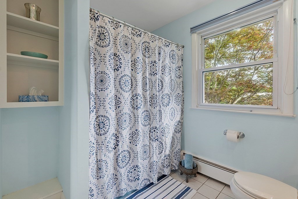 14 Scenna Road Beverly, MA 01915 - Photo 23 of 42 a bathroom with a toilet and a shower curtain