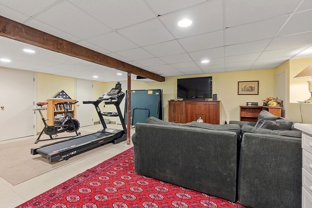 14 Scenna Road Beverly, MA 01915 - Photo 30 of 42 a living room with furniture gym equipment and a flat screen tv