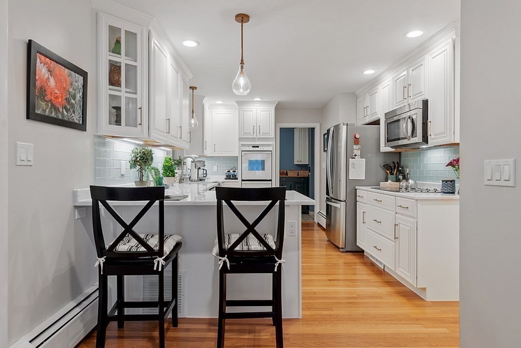 14 Scenna Road Beverly, MA 01915 - Photo 9 of 42 a kitchen with stainless steel appliances kitchen island granite countertop a dining table chairs cabinets and a sink