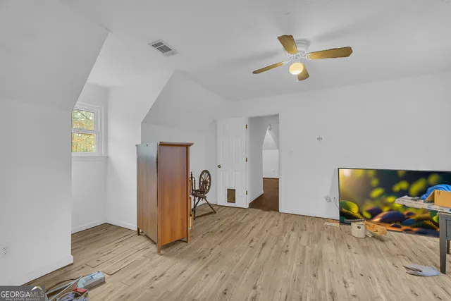 a living room with couch and a wooden floor