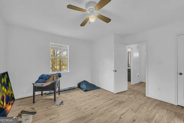 a bedroom with a bed and a flat tv screen on the dresser