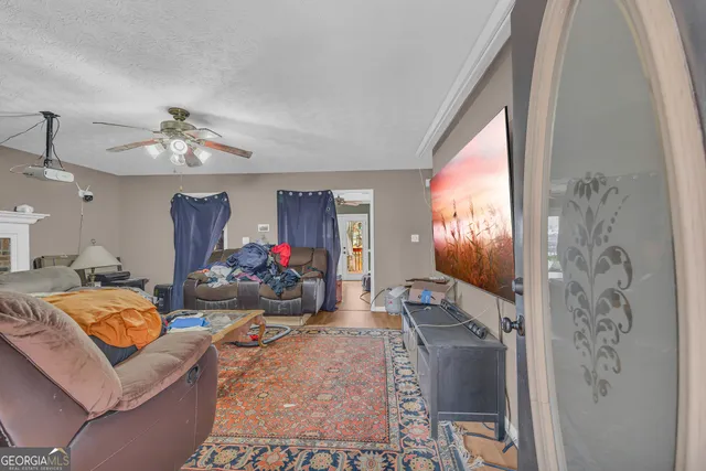 a living room with fireplace furniture and a wooden floor