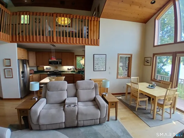 a living room with furniture a fireplace and a window