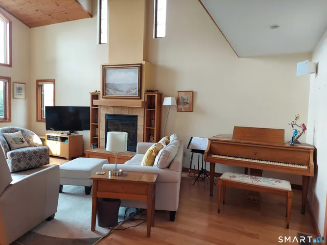 a living room with furniture a fireplace and a flat screen tv