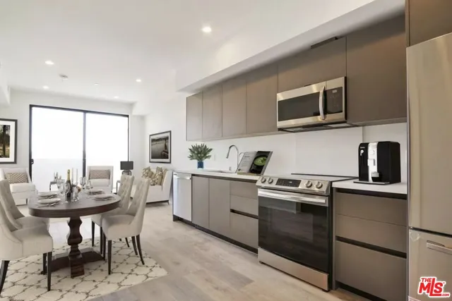 a kitchen with a stove a sink and a microwave