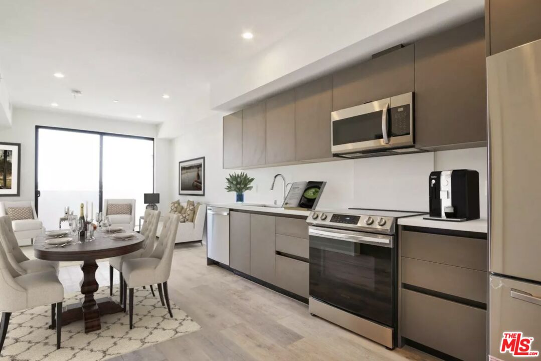 919 South Harvard Boulevard, Unit 403 Los Angeles, CA 90006 - Photo 1 of 9 a kitchen with a stove a sink and a microwave
