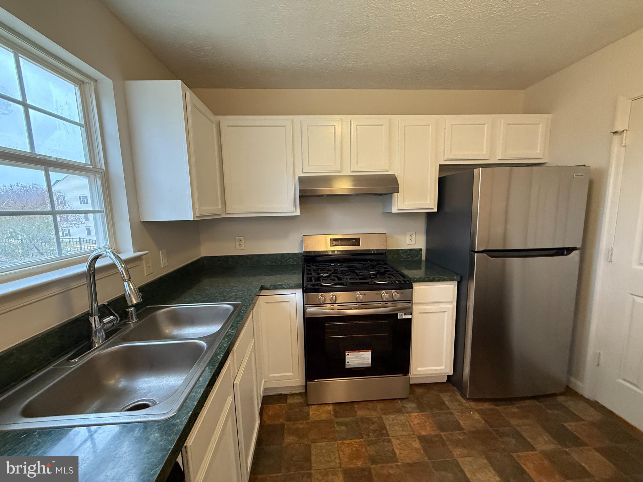 4345 Normandy Court Fredericksburg, VA 22408 - Photo 11 of 44 a kitchen with a sink stove and refrigerator