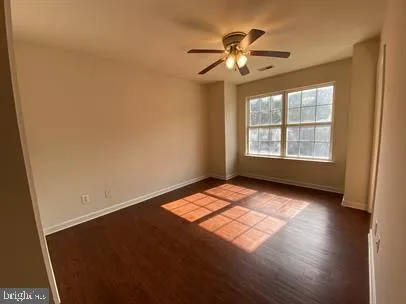 a view of wooden floor and windows in a room