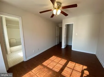 a view of a big room with wooden floor and windows