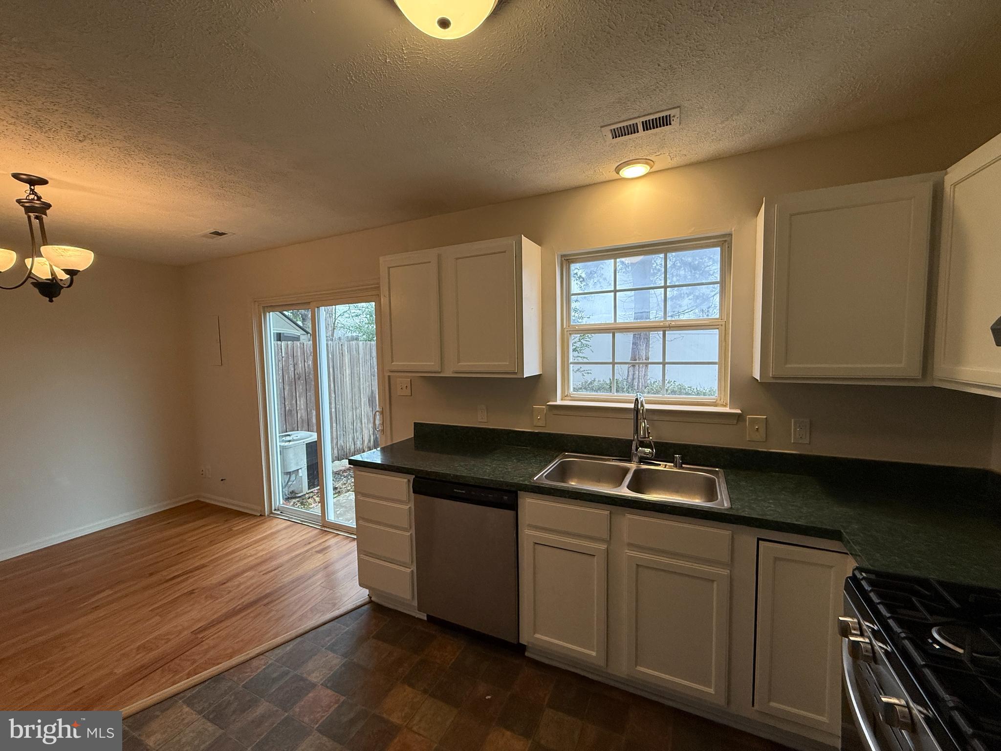 4345 Normandy Court Fredericksburg, VA 22408 - Photo 14 of 44 a kitchen with granite countertop a sink a window stainless steel appliances and cabinets
