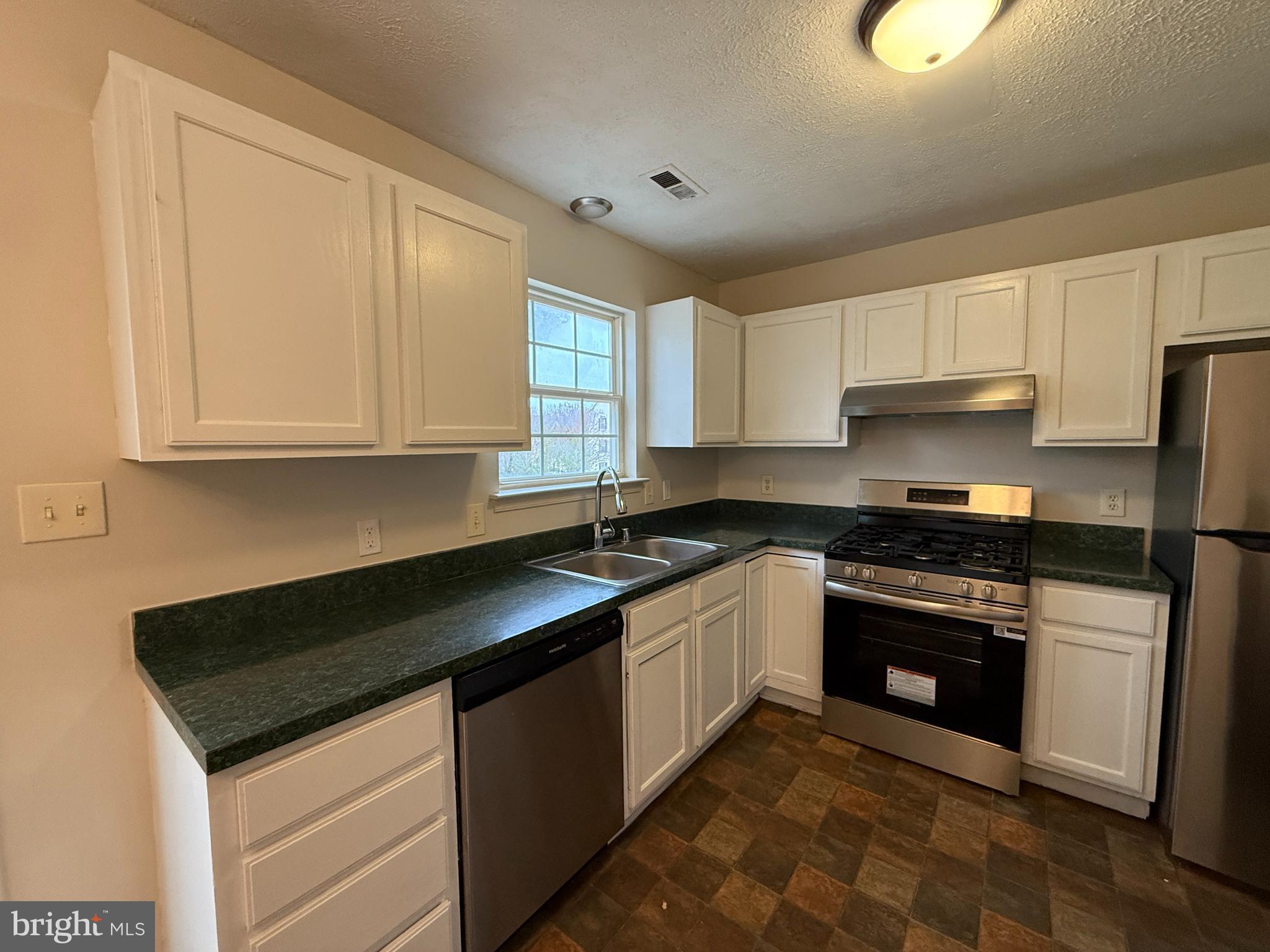 4345 Normandy Court Fredericksburg, VA 22408 - Photo 10 of 44 a kitchen with granite countertop a sink stainless steel appliances and cabinets