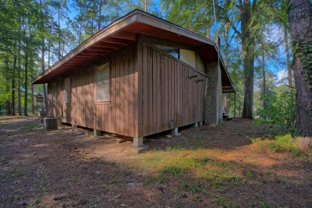 a view of a backyard with table and chairs and a barbeque