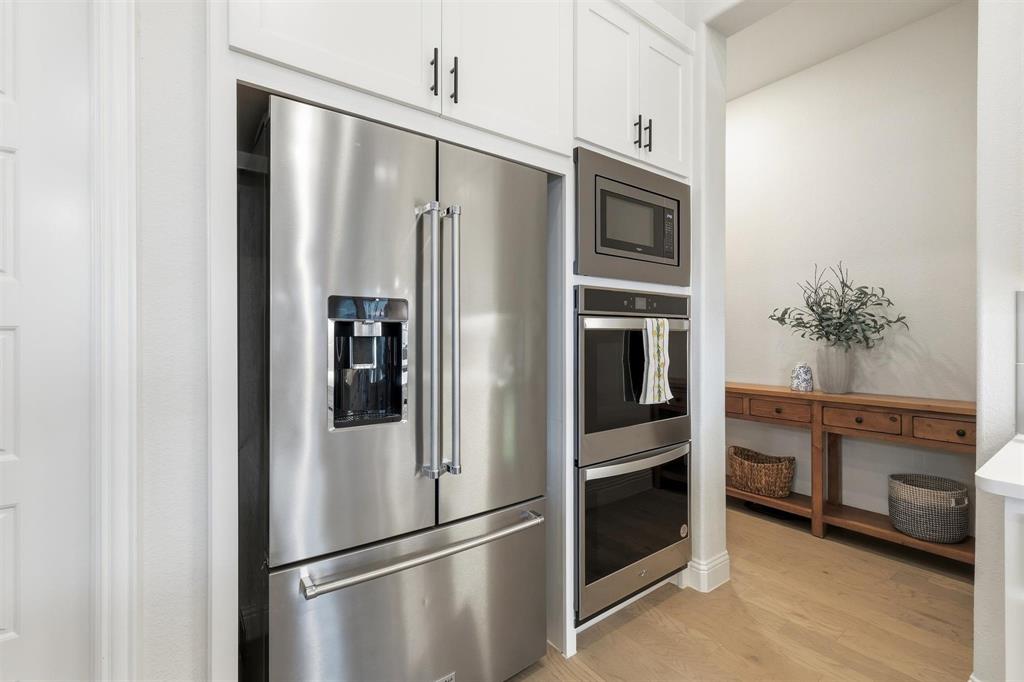11116 Emory Oak Ridge Flower Mound, TX 76226 - Photo 13 of 40 a metallic refrigerator freezer sitting in a kitchen