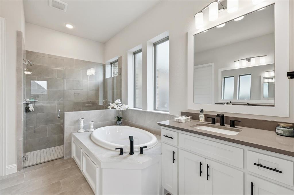 11116 Emory Oak Ridge Flower Mound, TX 76226 - Photo 18 of 40 a bathroom with a tub sink and mirror