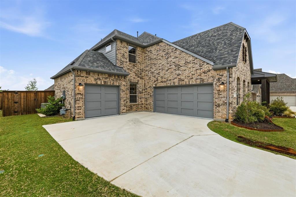 11116 Emory Oak Ridge Flower Mound, TX 76226 - Photo 2 of 40 a front view of a house with a yard and garage
