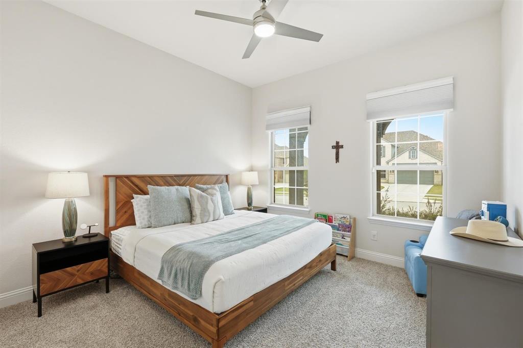 11116 Emory Oak Ridge Flower Mound, TX 76226 - Photo 22 of 40 a bedroom with a bed and window
