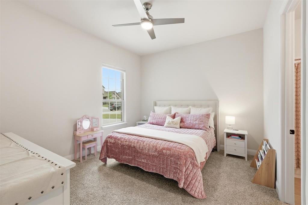 11116 Emory Oak Ridge Flower Mound, TX 76226 - Photo 24 of 40 a bedroom with a bed and a window