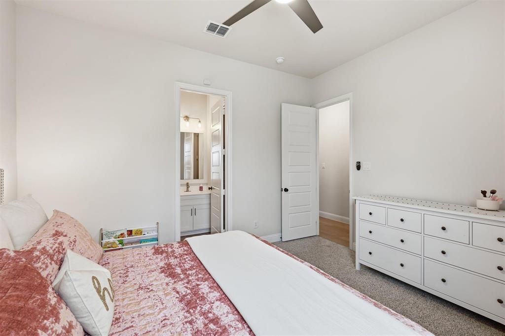 11116 Emory Oak Ridge Flower Mound, TX 76226 - Photo 25 of 40 a bedroom with a bed and a dresser