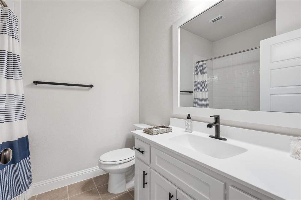11116 Emory Oak Ridge Flower Mound, TX 76226 - Photo 28 of 40 a bathroom with a sink a toilet and a mirror