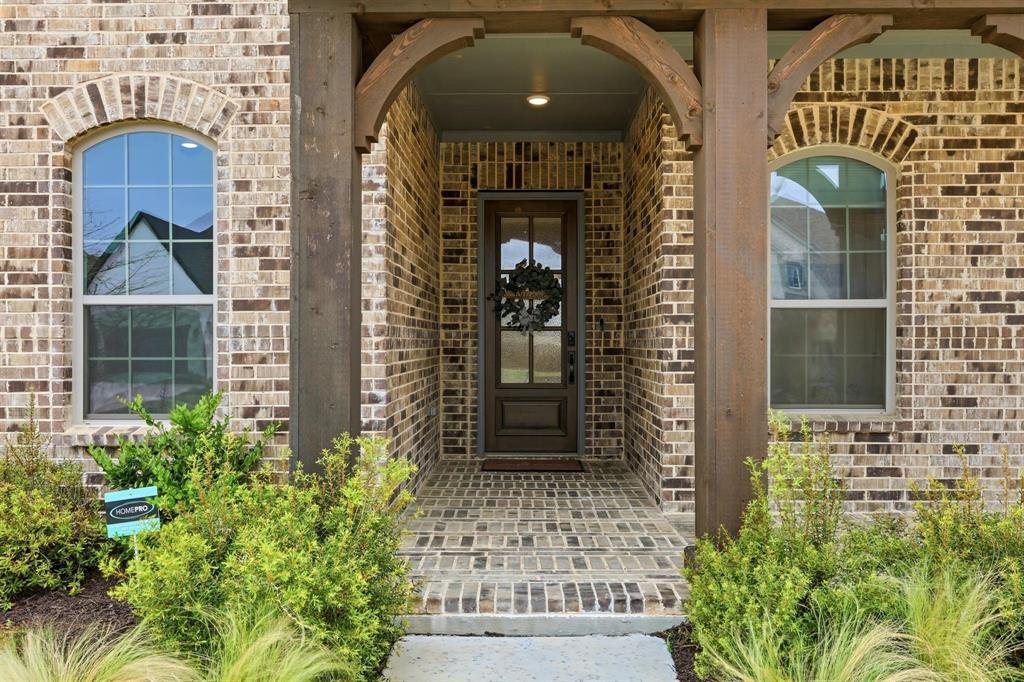 11116 Emory Oak Ridge Flower Mound, TX 76226 - Photo 3 of 40 a front view of a house with a glass door
