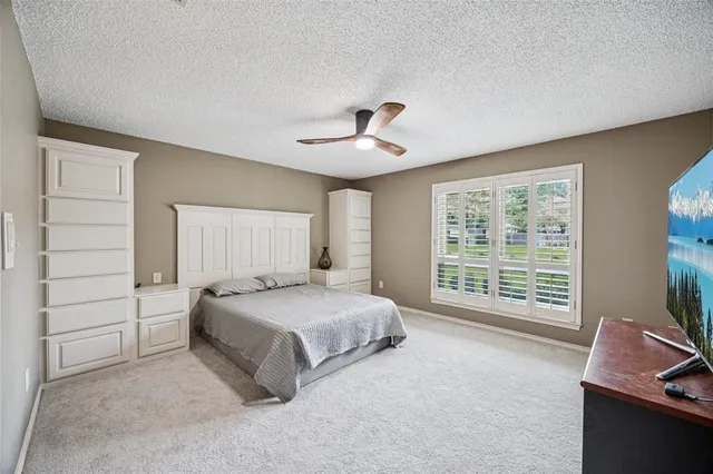 a spacious bedroom with a bed and a window