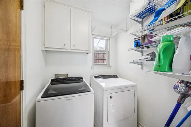 a utility room with sink dryer and washer
