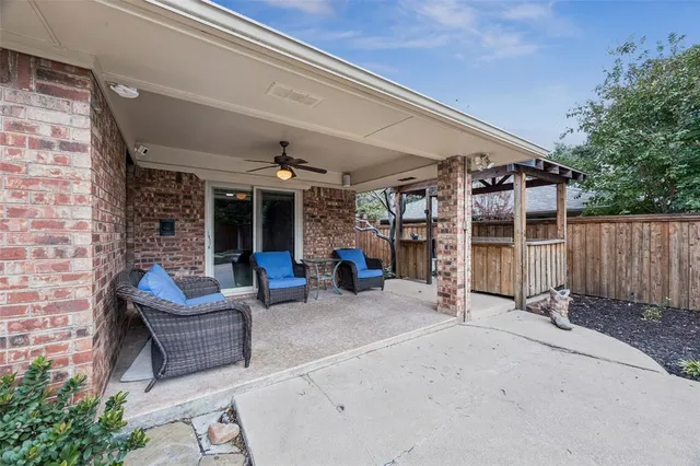 a view of a patio with table and chairs