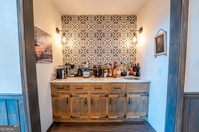 a open kitchen with stainless steel appliances granite countertop a refrigerator a sink dishwasher a stove and white countertops with wooden floor