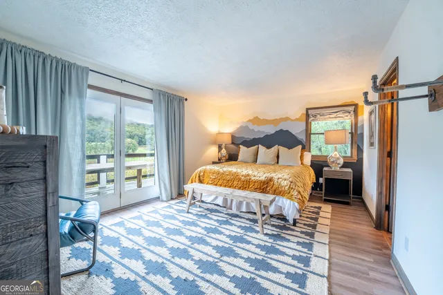 a bedroom with a bed and a painting on the wall