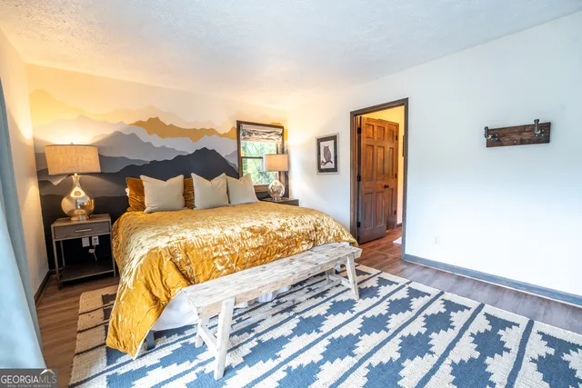 a en suite bathroom with a granite countertop sink and a mirror