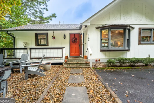 a front view of house with a garden