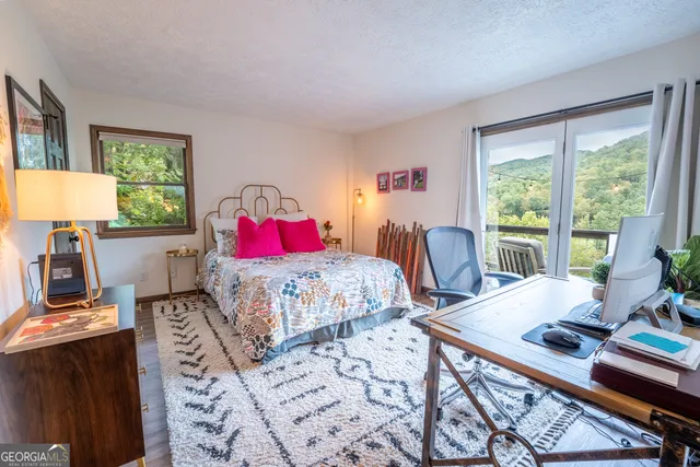 a bed room with a bed and a large window