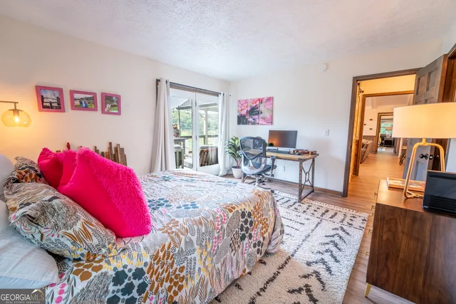 a bathroom with a granite countertop sink mirror vanity and toilet