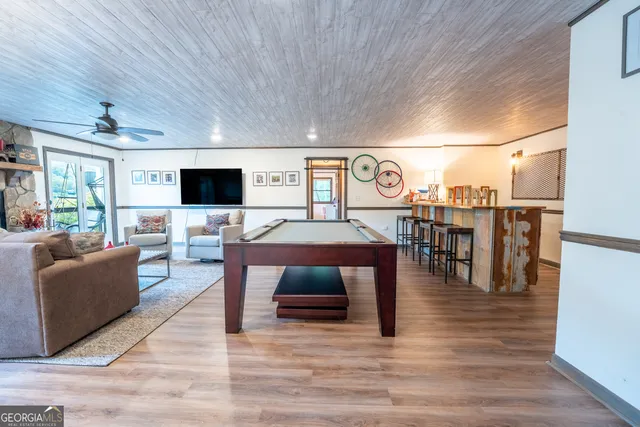 a view of a hallway with wooden floor and front door