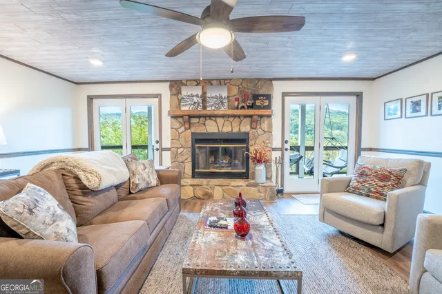 a bedroom with two beds and a dresser next to a window