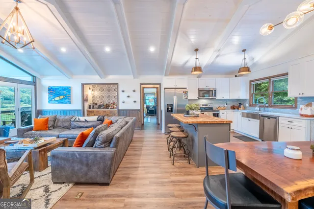 a living room with furniture a fireplace and a floor to ceiling window
