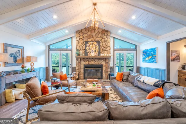 a living room with furniture a fireplace and a flat screen tv