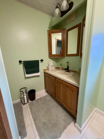 a kitchen with a sink dishwasher and a refrigerator with wooden floor