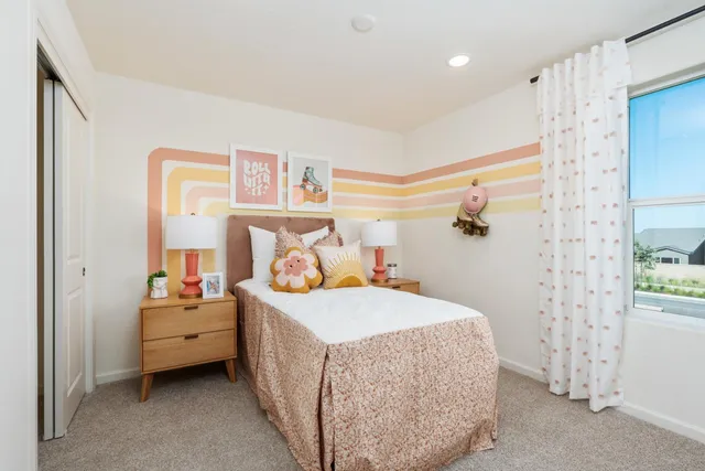 a bedroom with a bed and a table