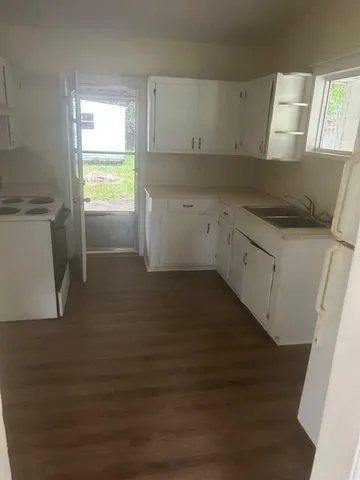 a kitchen with a sink a window and appliances