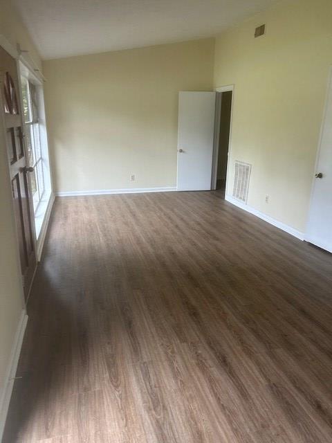 2727 Rice Street Columbus, GA 31903 - Photo 5 of 5 an empty room with wooden floor and entrance
