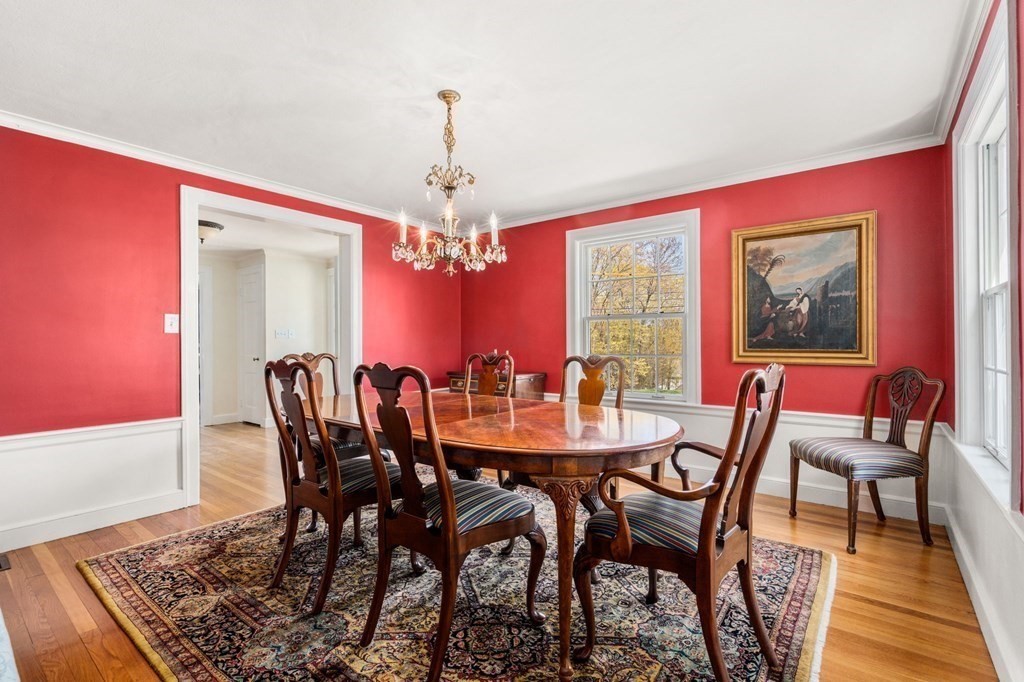 144 Reservoir Road Brookline, MA 02467 - Photo 5 of 21 a view of a dining room with furniture a chandelier and wooden floor