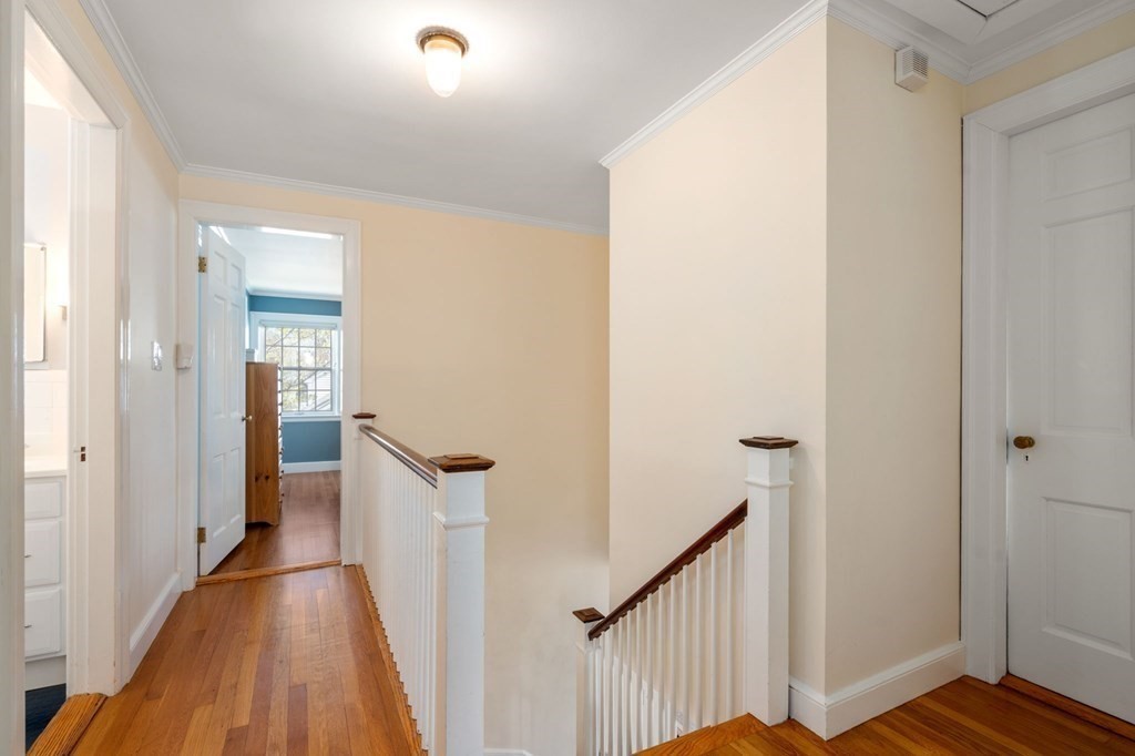 144 Reservoir Road Brookline, MA 02467 - Photo 10 of 21 a view of a hallway with wooden floor and staircase