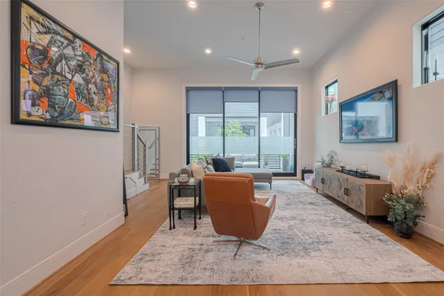 a living room with furniture rug and wooden floor