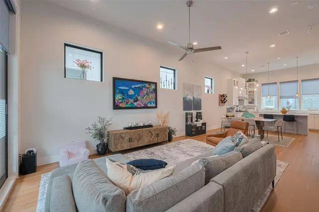 a bedroom with a bed a couch and a flat screen tv